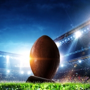 Football in Lit Up Stadium