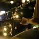 Man Sitting Playing Guitar & Singing