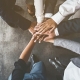 Business people putting their hands together