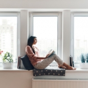 Woman Reading Book near Window