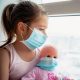 Young Girl with Doll Wearing Mask