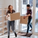 Couple Moving Boxes into Home