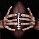 Football Player Holding Ball