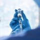 Doctor Holding Vaccine Syringe