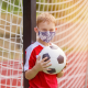 Young Boy Playing Sports with Mask