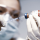 Doctor Holding Coronavirus Vaccine Syringe